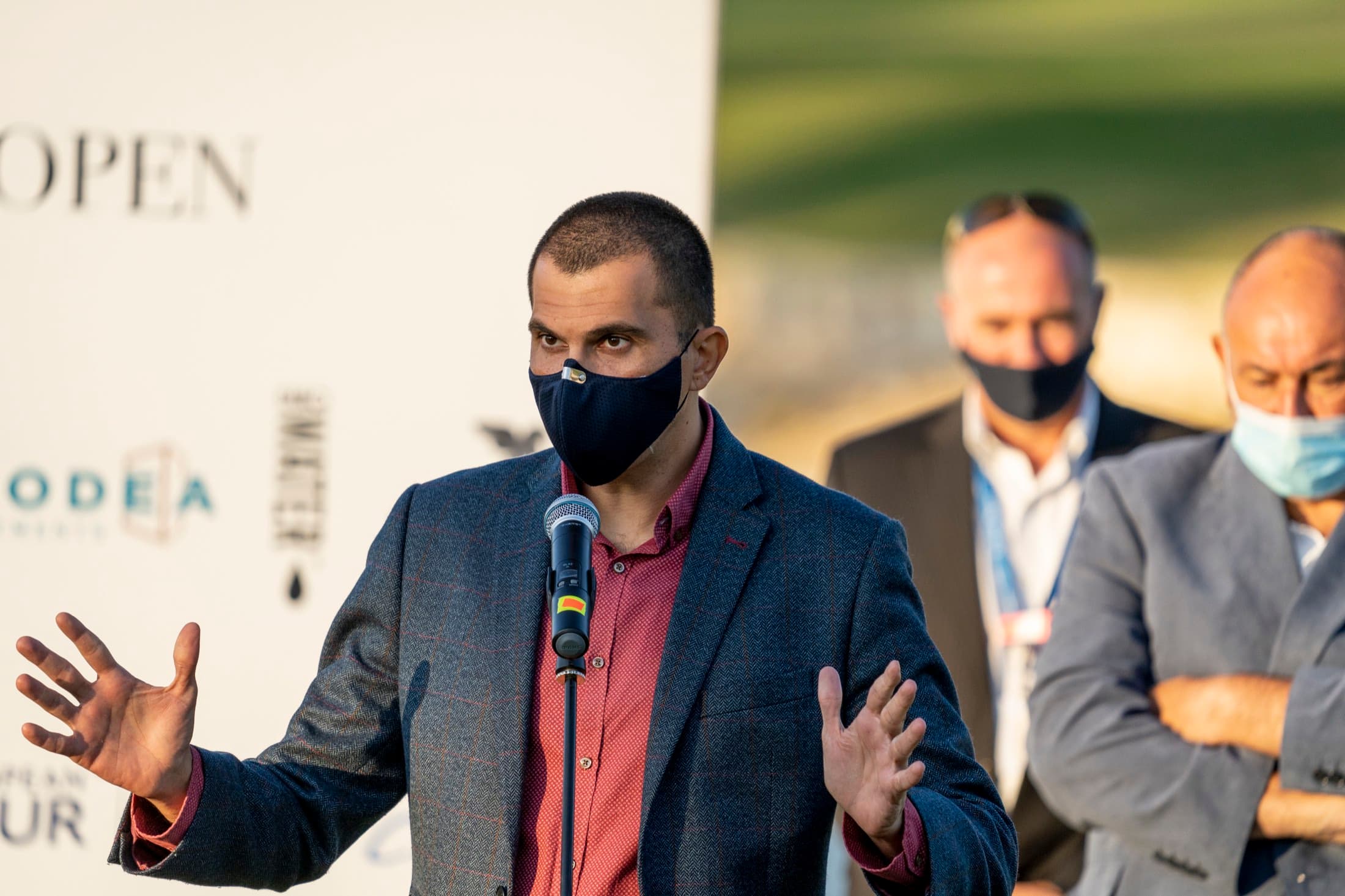 A masked speaker addresses masked officials at the 2020 European Tour ceremony at Aphrodite Hills, Cyprus, documented by Backlight Media