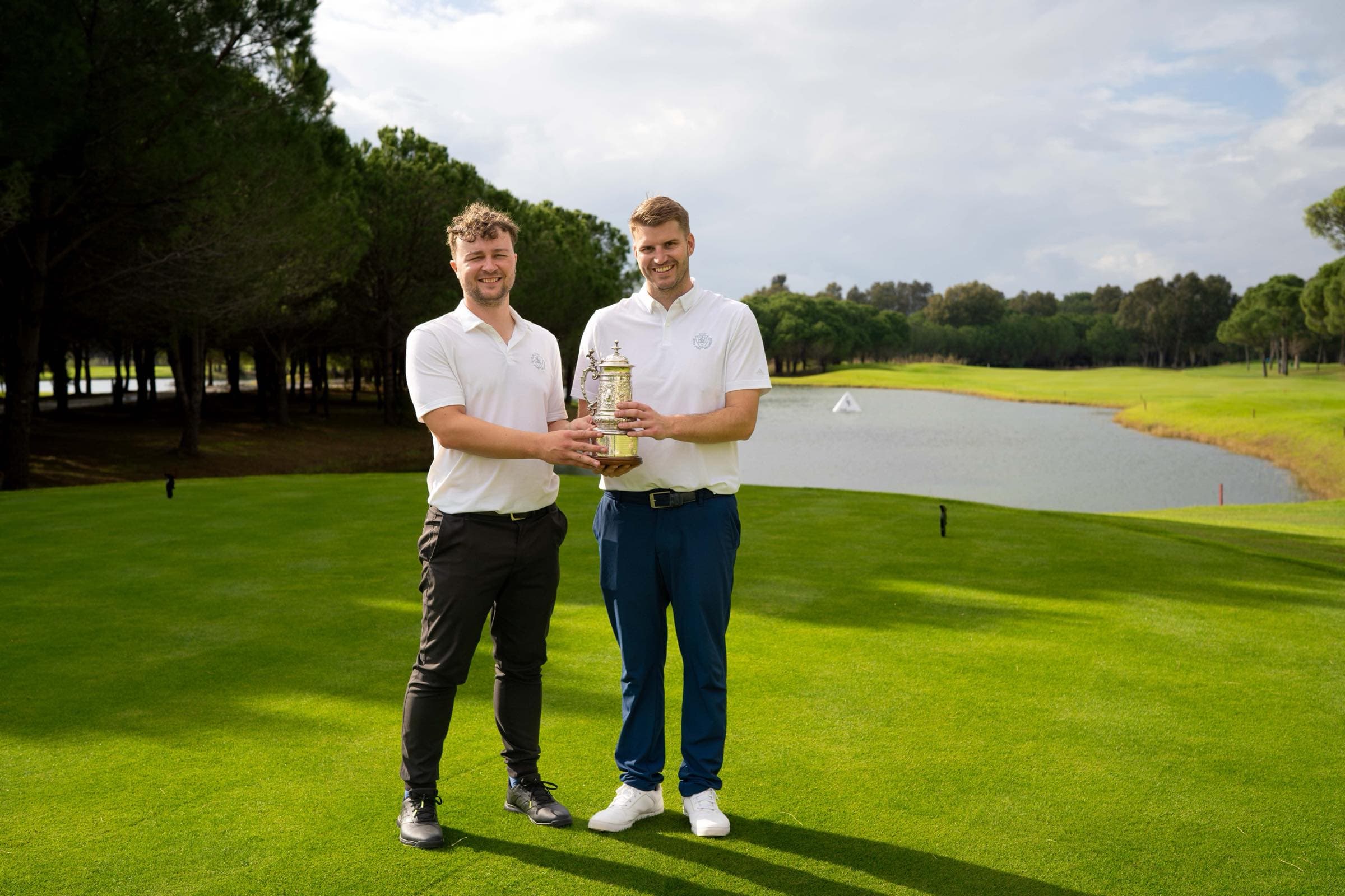 Winning pair holding the trophy on the course at the St James's Place PGA event, Antalya Golf Club, Turkey, by Backlight Media