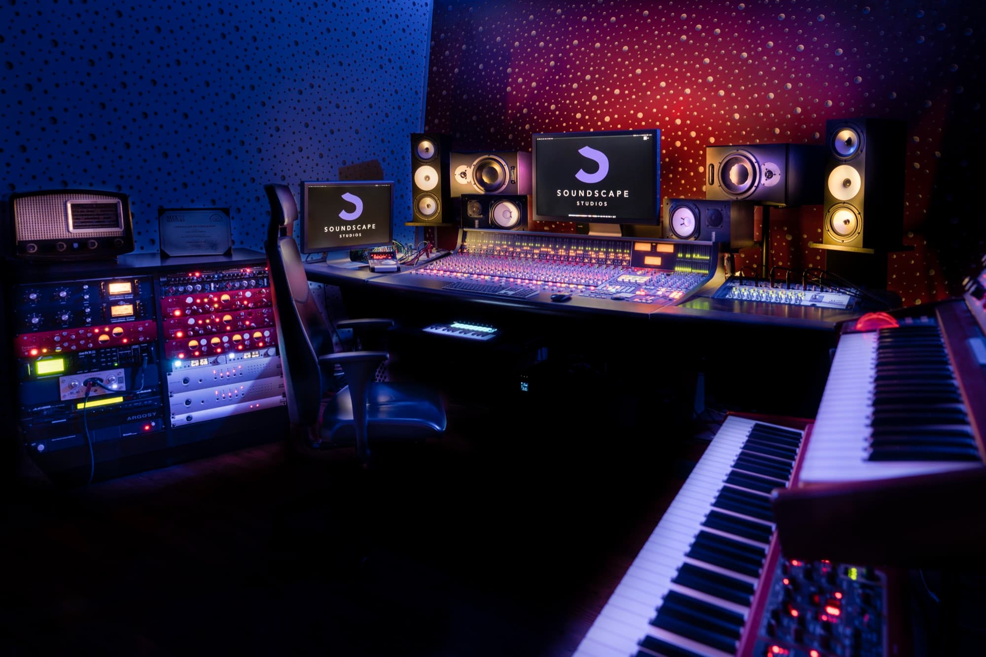 Low-light view of the Soundscape Studios control room with outboard gear and a vintage radio, shot by Backlight Media